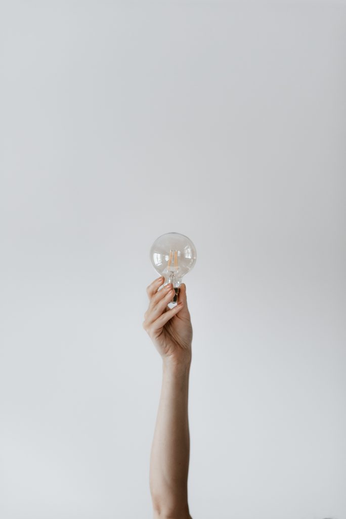 hand raised holding a lightbulb