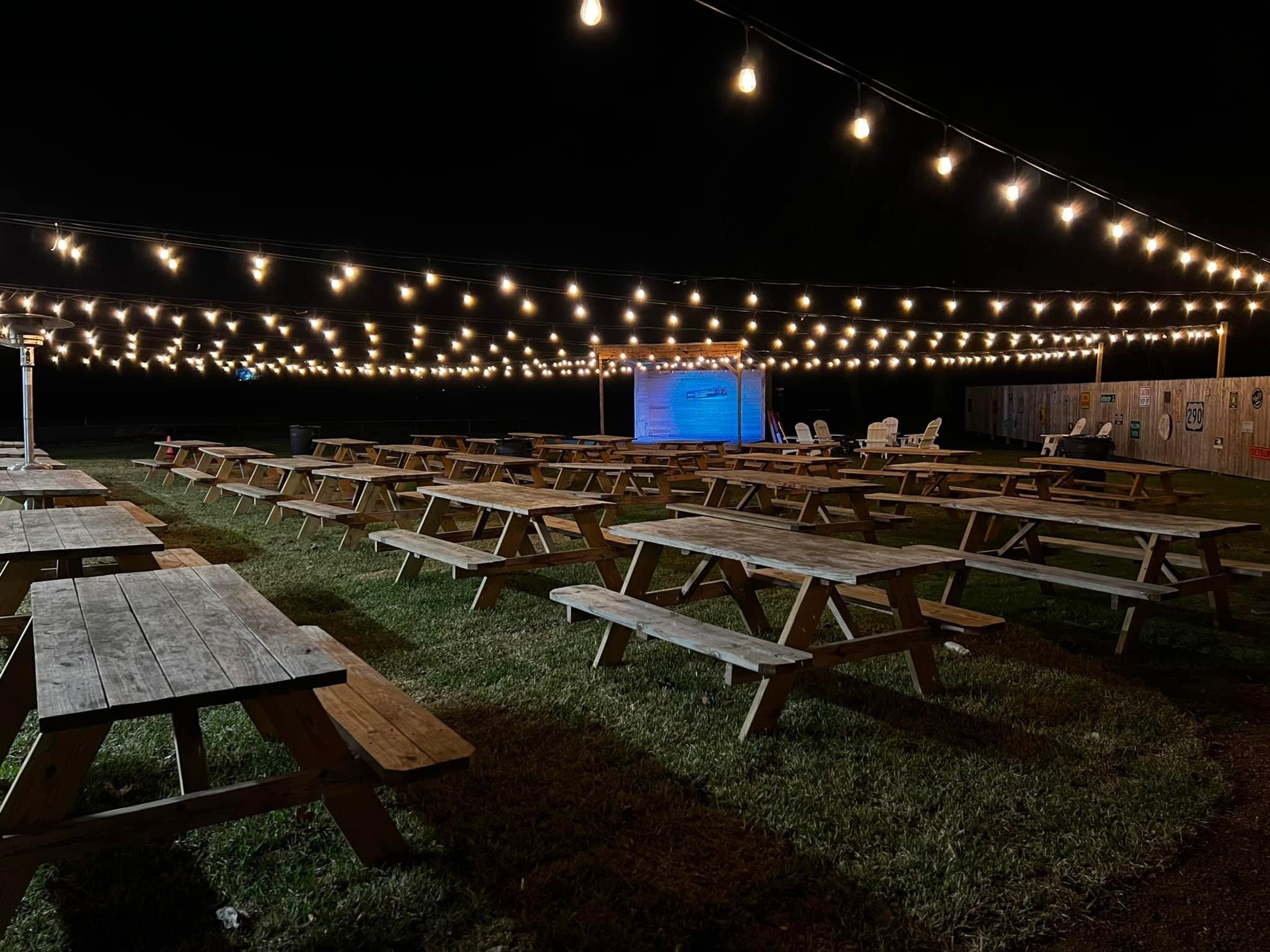 outdoor area with picnic tables and lights