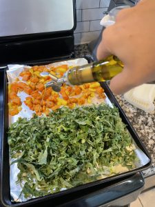 veggies being drizzled with EVOO