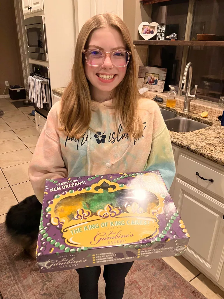 teenager holds King Cake