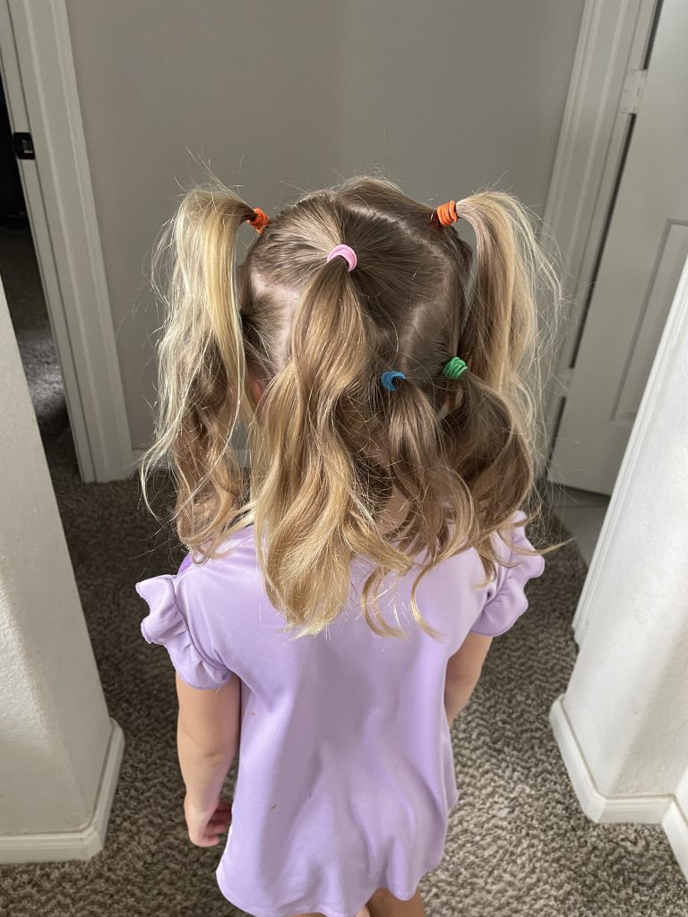 back view of girl's hair with multiple ponytails