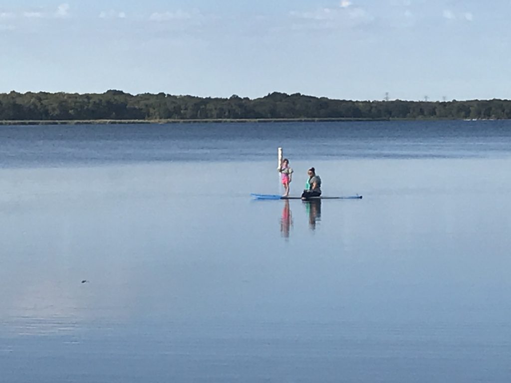 man and daughter out on lake