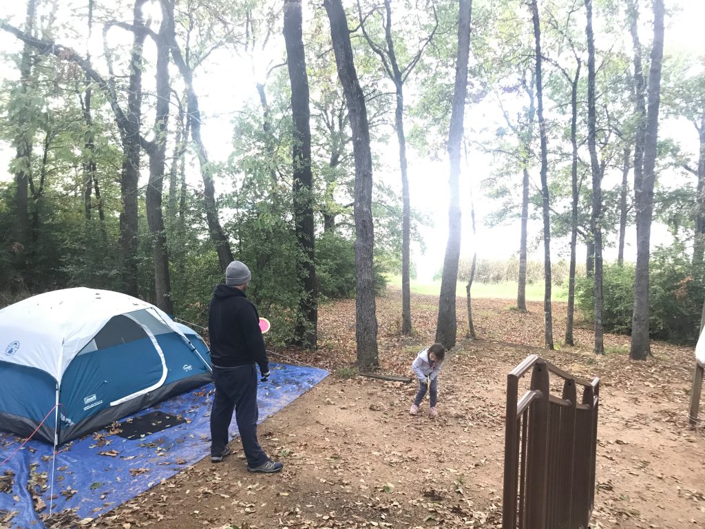 family with tent set up on campground
