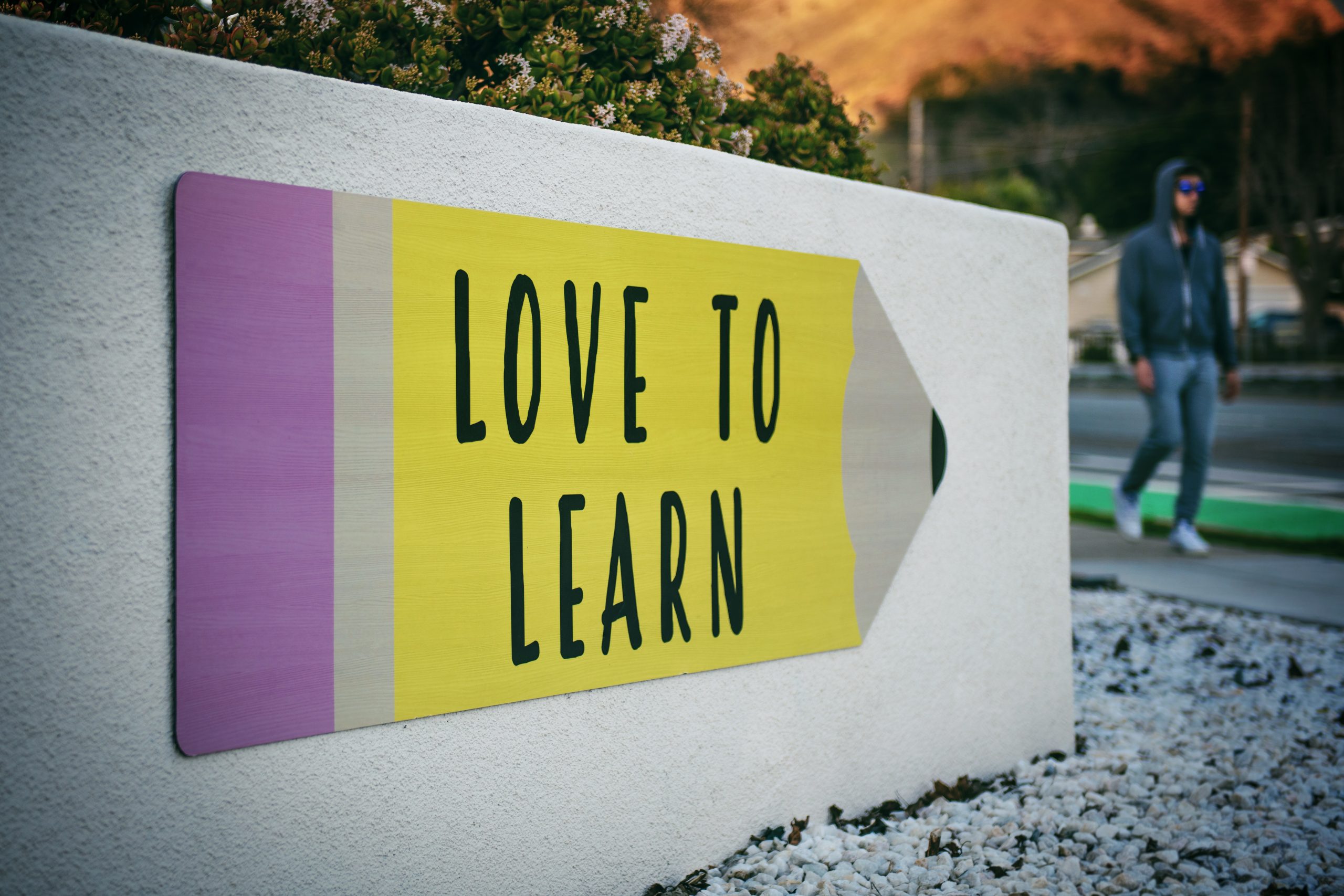 sign with large pencil that says "Love to Learn"