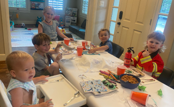 children sitting at table celebrating Passover with activities