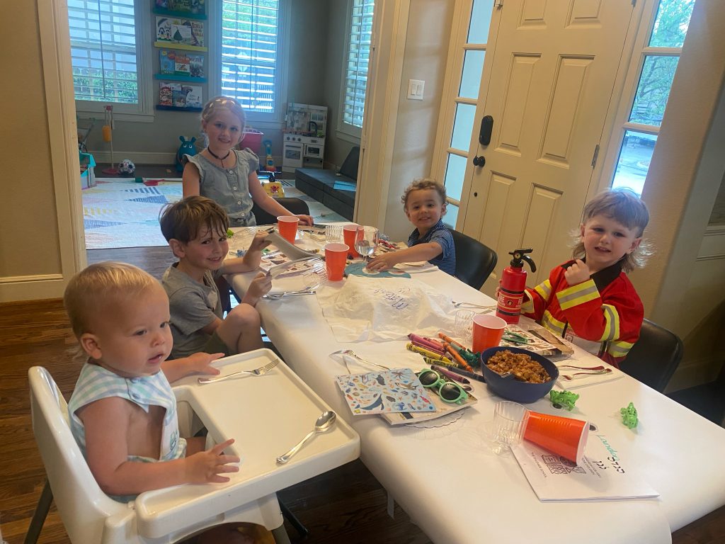 Small children gathered around Passover table