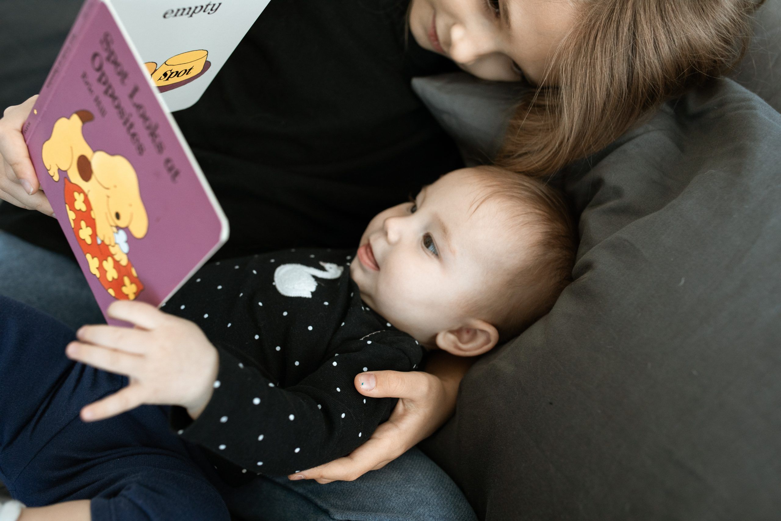 mother reading to young baby