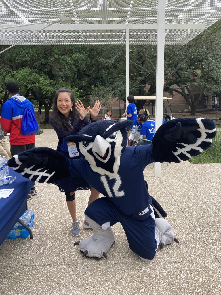 Woman in front of Rice Owl mascot