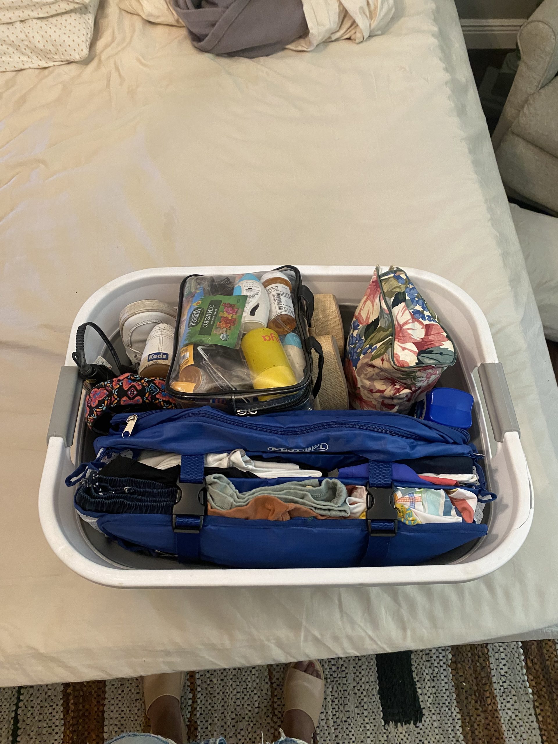 laundry basket full of clothes and toiletries