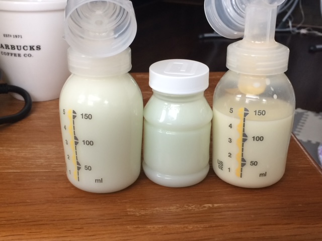 3 containers of pumped breastmilk sit on table 