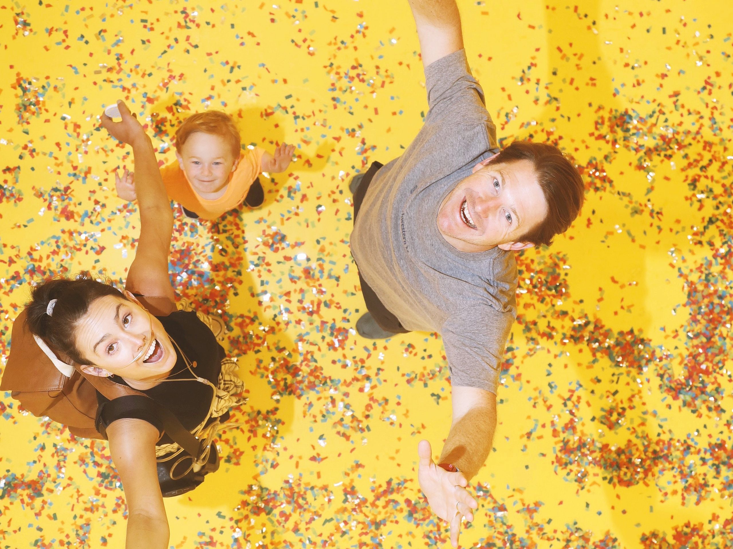 family looking up, surrounded by confetti