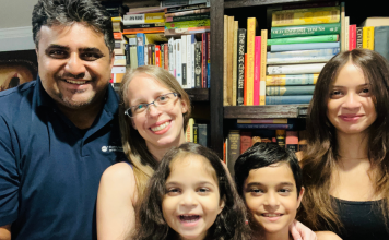 family of 5 in front of bookshelf