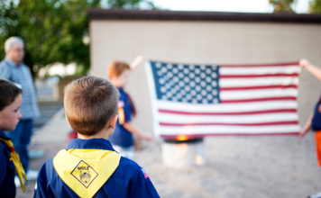 boy scouts in front of American flag