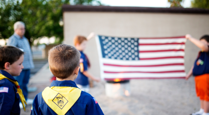 boy scouts in front of American flag