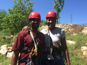 couple with helmets and ziplining gear