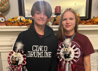 high school couple wearing homecoming mums