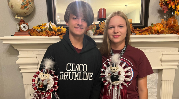 high school couple wearing homecoming mums