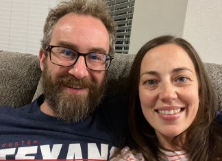 couple sits on couch for date night in