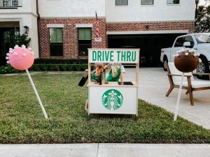 Two boys behind a replica Starbucks' drive-thru for Halloween