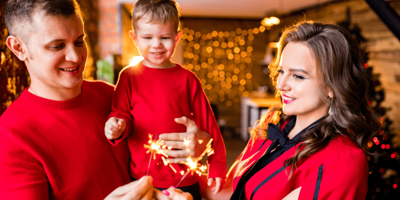 Family with sparklers celebrating New Year's Eve in their home