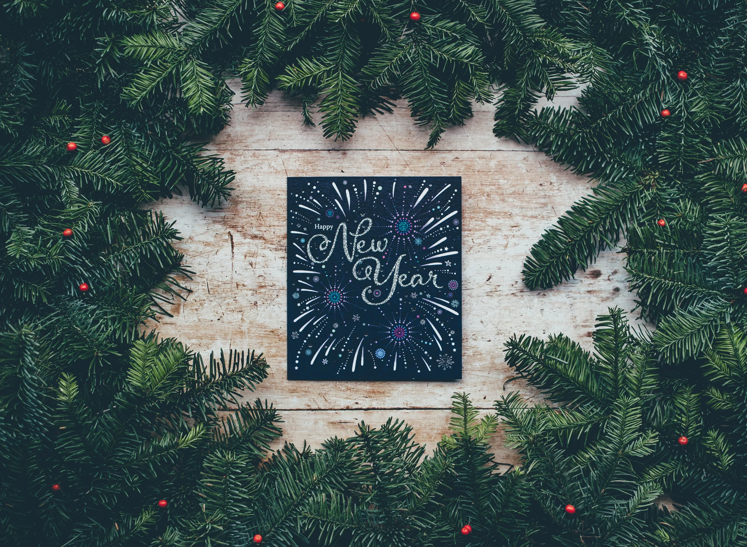 New Year sign surrounded by pine branches