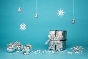 silver package and ornaments on teal background