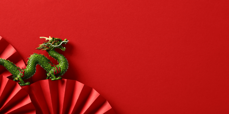 red background with Chinese dragon and fan