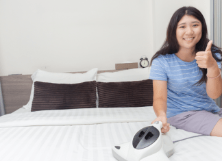 Woman finishes one of the yearly tasks- cleaning her mattress- and gives thumbs up