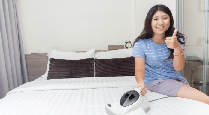 Woman finishes one of the yearly tasks- cleaning her mattress- and gives thumbs up