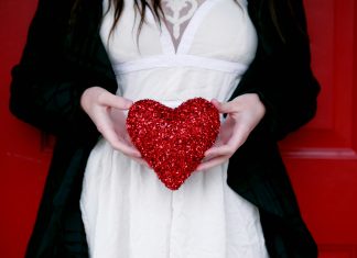 Valentine’s Day Gifts for Everyone You Love A woman holding a sparkling red heart
