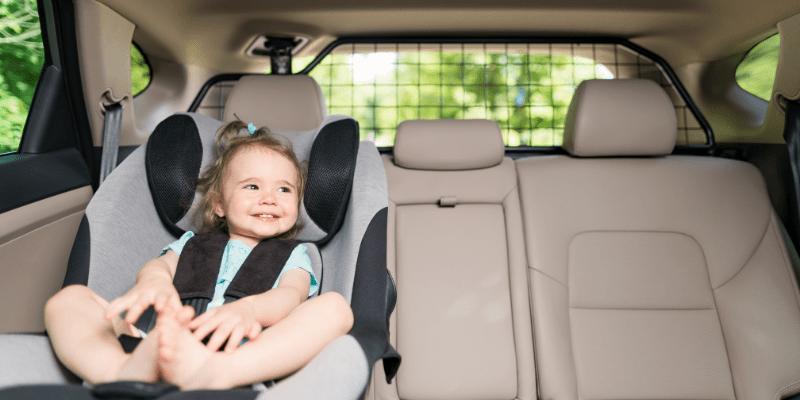 girl smiling in carseat