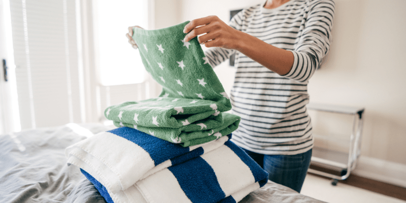 woman folds towels