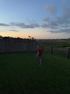 child plays golf in backyard