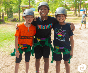 Three boys in ropes course equipment