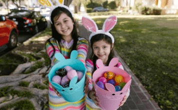 girls hold Easter baskets with plastic eggs inside