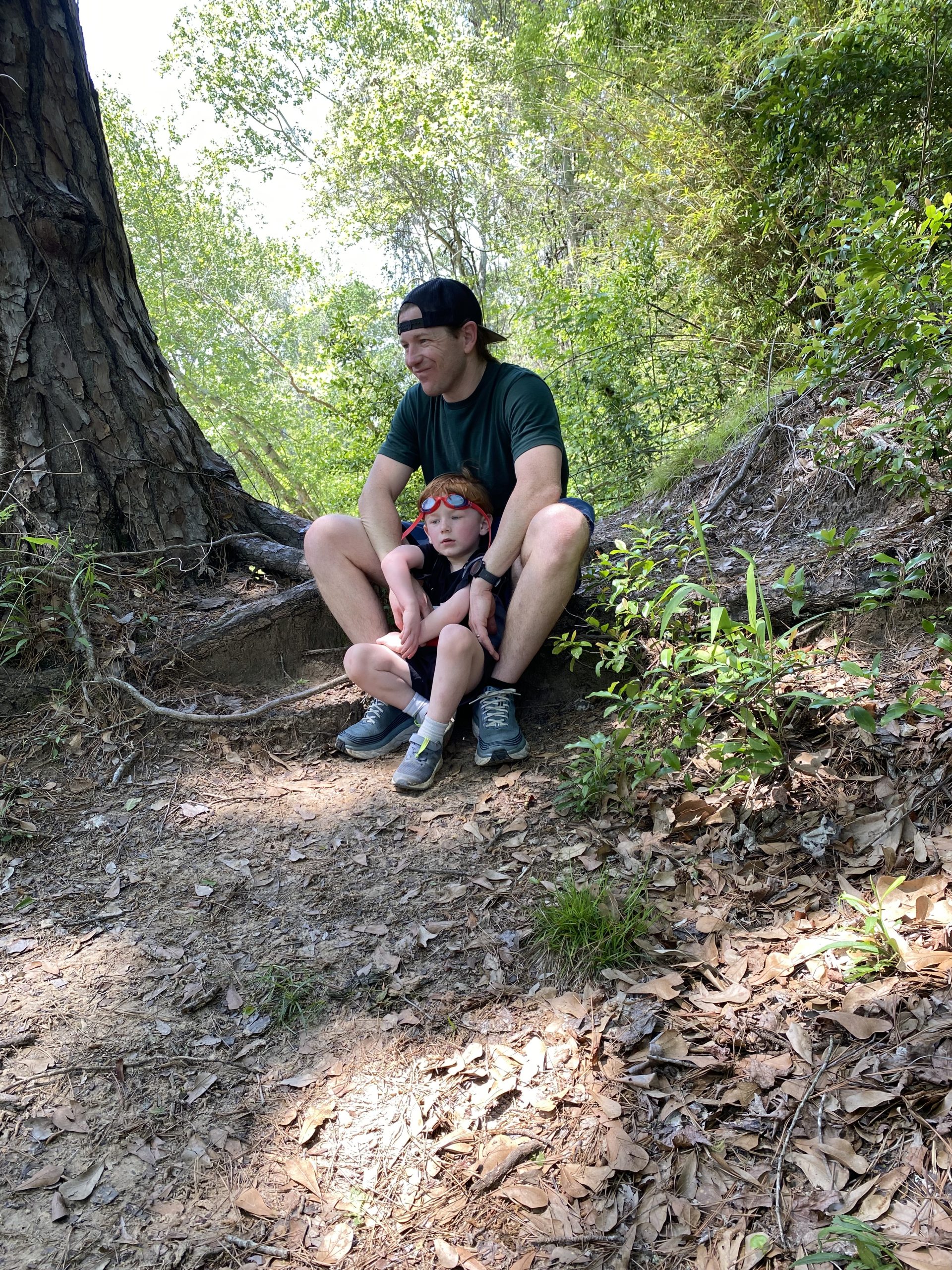 Dad and son sitting in woods