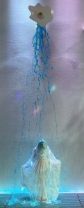 woman in white dress in room of pastel lights