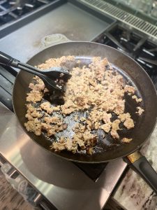 pan of sausage being browned