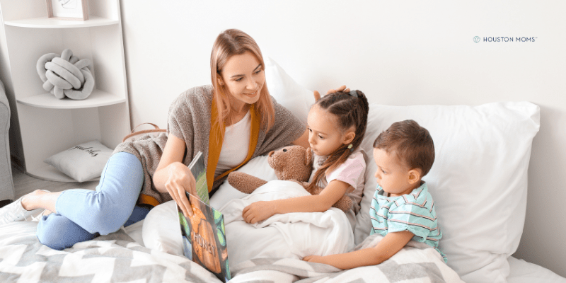 family on bed reading bedtime stories