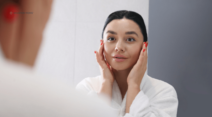 Classic Beauty Products that Stand the Test of Time woman with face on hands looks in mirror