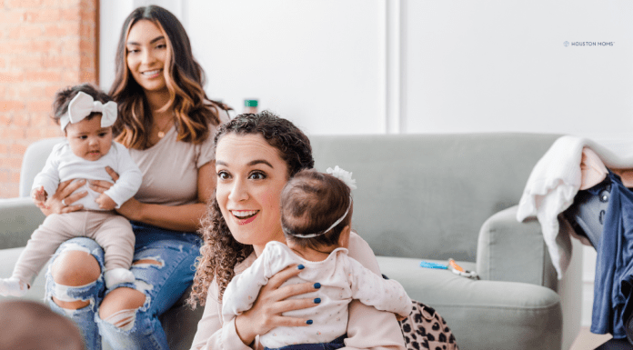 first-time mom holding baby while gathering with another mom with baby