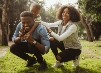 The Consequences of Pregnancy: Co-Parenting man and woman playing outside with child