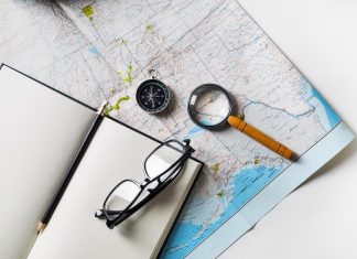 Using Core Values to Guide Your Life image of an open blank journal, a compass and magnifying glass on a map