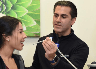 New Look, Same Values: Next Level is Committed to Houston Families Man taking woman's temperature in clinic