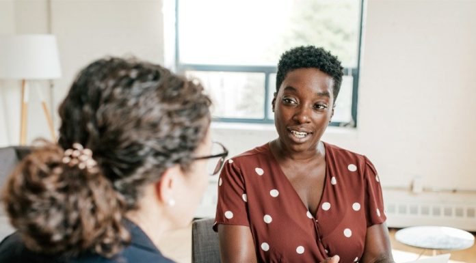 Knowledge is Power: Guidance for Divorce Two women talking at a table while holding papers