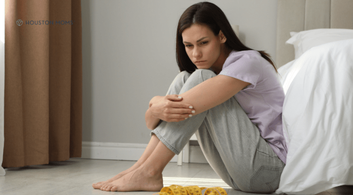 8 Warning Signs and 8 Truths of Eating Disorders woman sits on floor sadly looking at scale