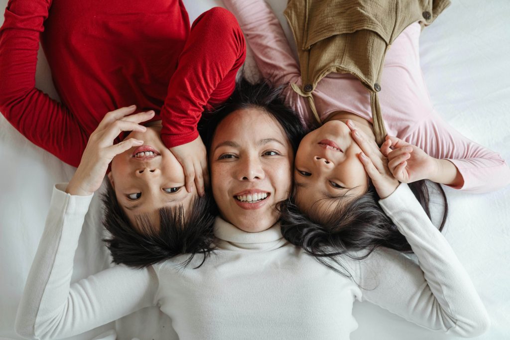 Woman smiles with her children.