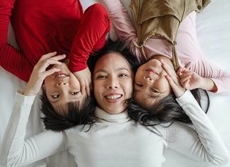 Everything You Need to Know About Blepharoplasty Woman smiles with her children.