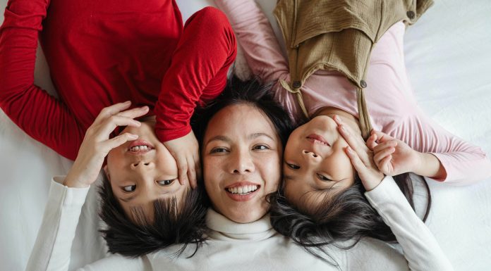 Everything You Need to Know About Blepharoplasty Woman smiles with her children.