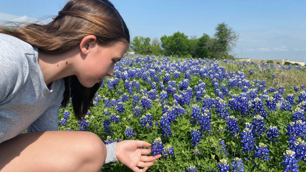 Teen girl in a field of bluebonnets near Brenham